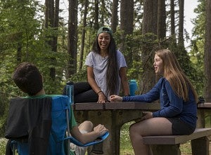 Students talking outdoors at picnic table