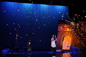 Man stands on stage and performs during a theatre play.