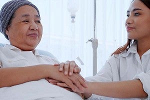 doctor holding elderly patient's hand