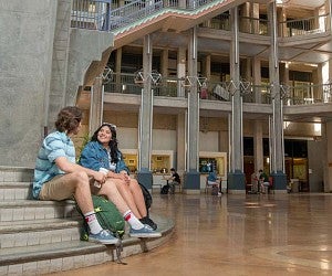 two students sitting on steps