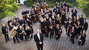 The UO Symphony Orchestra holding instruments