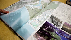 Open book with map of Yellowstone.