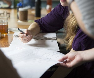 Student writing in journal (Center for Teaching and Writing)