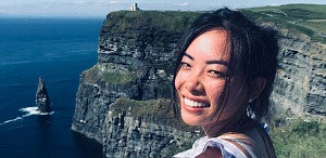 student standing near cliffs in Ireland