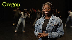 portrait of Hannah Thomas with other dancers in the background