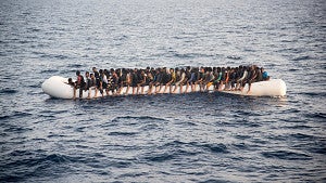Victims of the Syrian civil war on a inflatable boat in the sea from the film "50 Feet from Syria" (2015) 