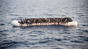 Victims of the Syrian civil war on a inflatable boat in the sea from the film "50 Feet from Syria" (2015)