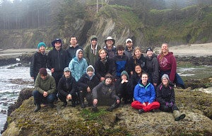 marine biology student group shot on rocky shore