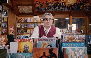 professor Ben Saunders browsing comic books in a store