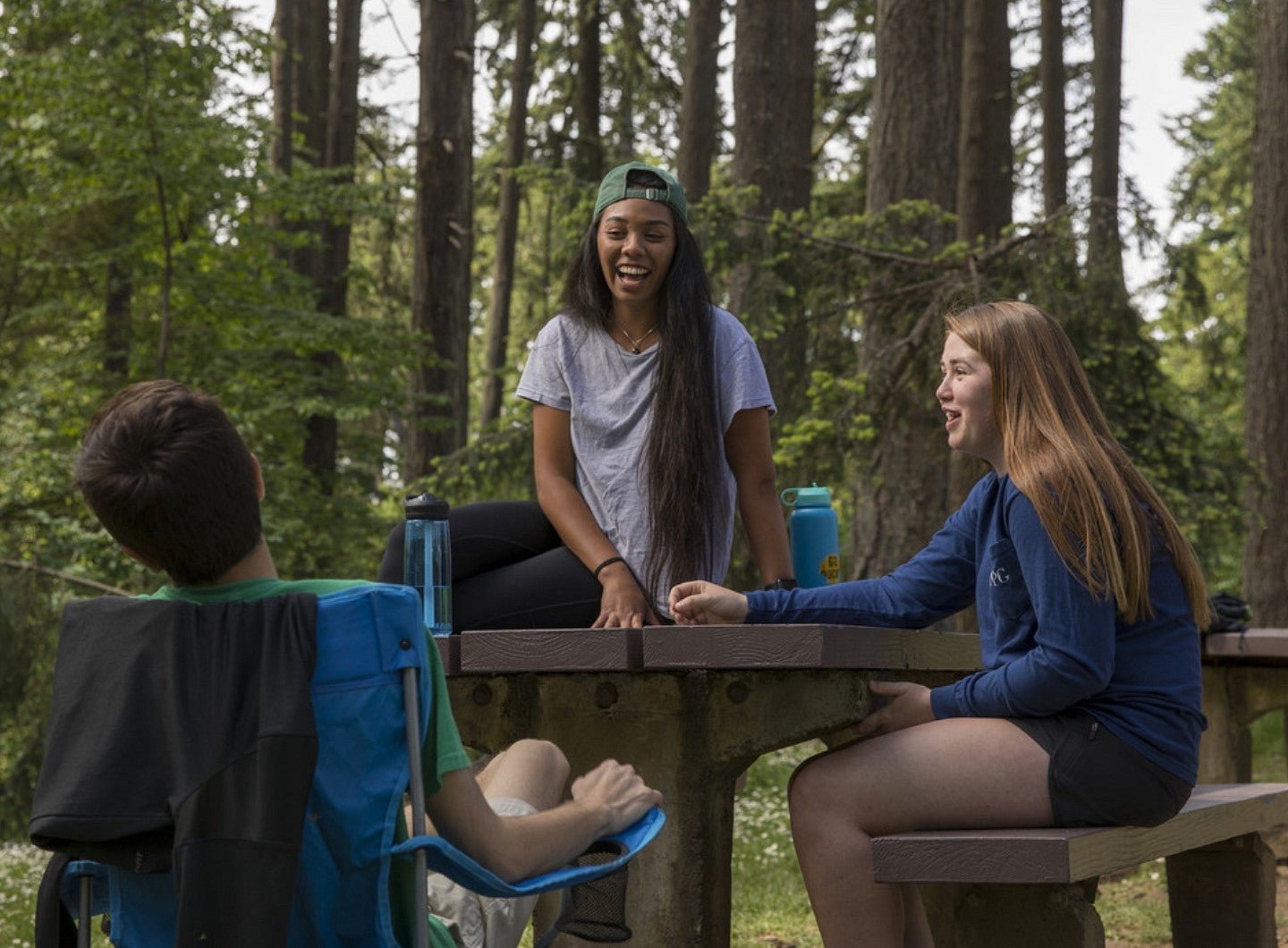 Students talking outdoors at picnic table