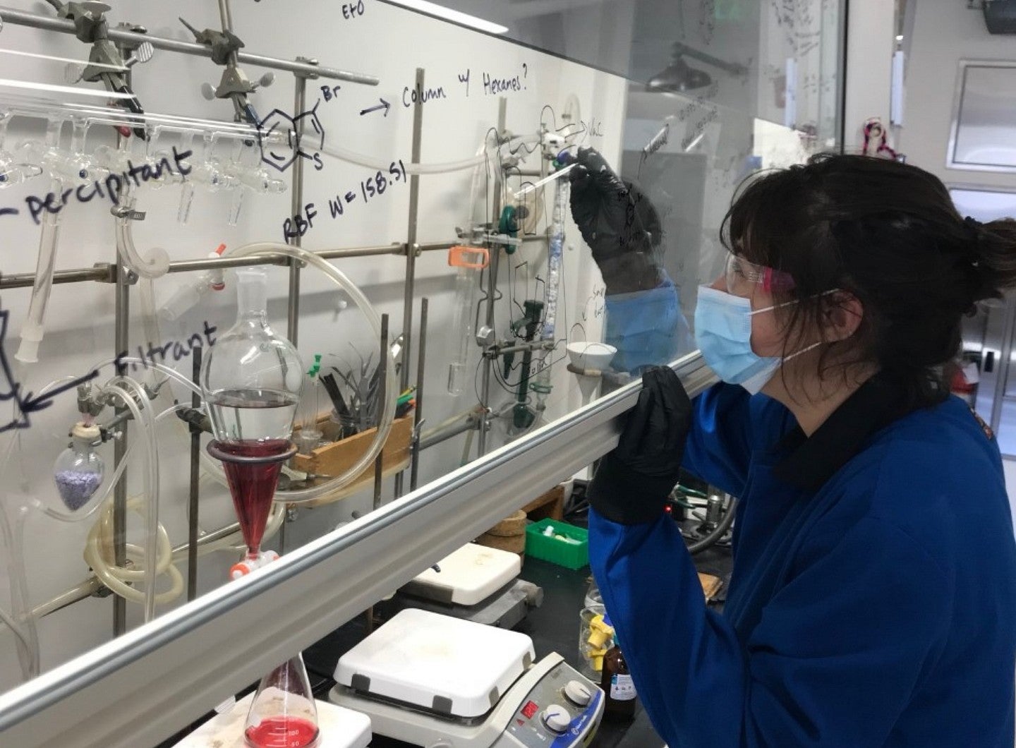 Researcher fills a vial with a liquid.