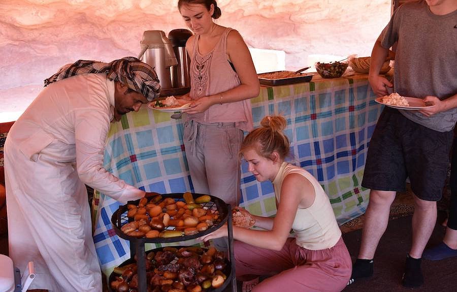 students at mealtime with bedouin hosts