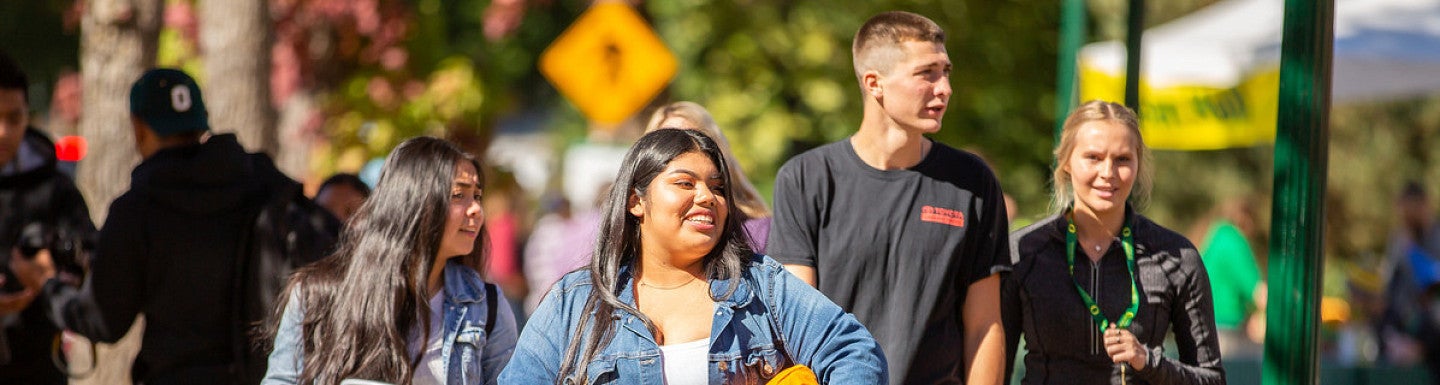 students walking and holding possessions during Unpack the quack day