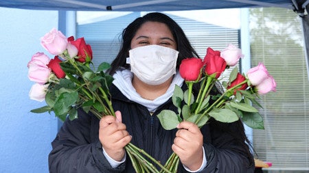 Sarai Villalobos, a UO testing coordinator, handed out roses to mothers getting tested on Mother’s Day weekend.