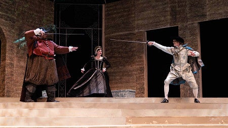 actors sword fight on stage