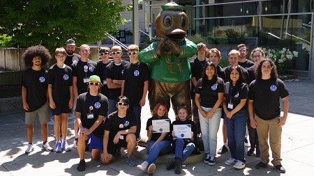 Group of high school students pose with Oregon Duck Statue