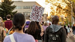 Protestors walk down the street.