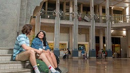 two students sitting on steps