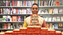 Nathan Harris holds his recent novel