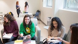 Students gathered and seated in community building space.