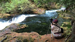 Person making a video of the McKenzie River