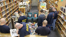 Participants look at books in a library
