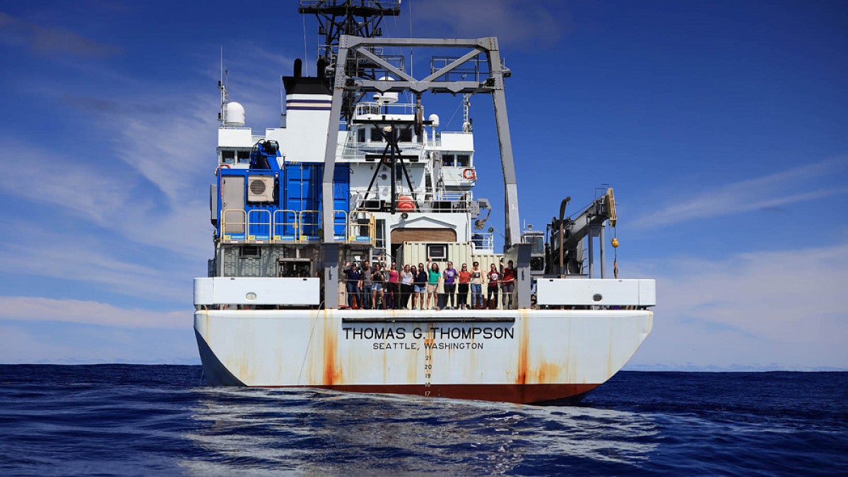 the OIMB research team group portrait on the deck of a research boat at sea