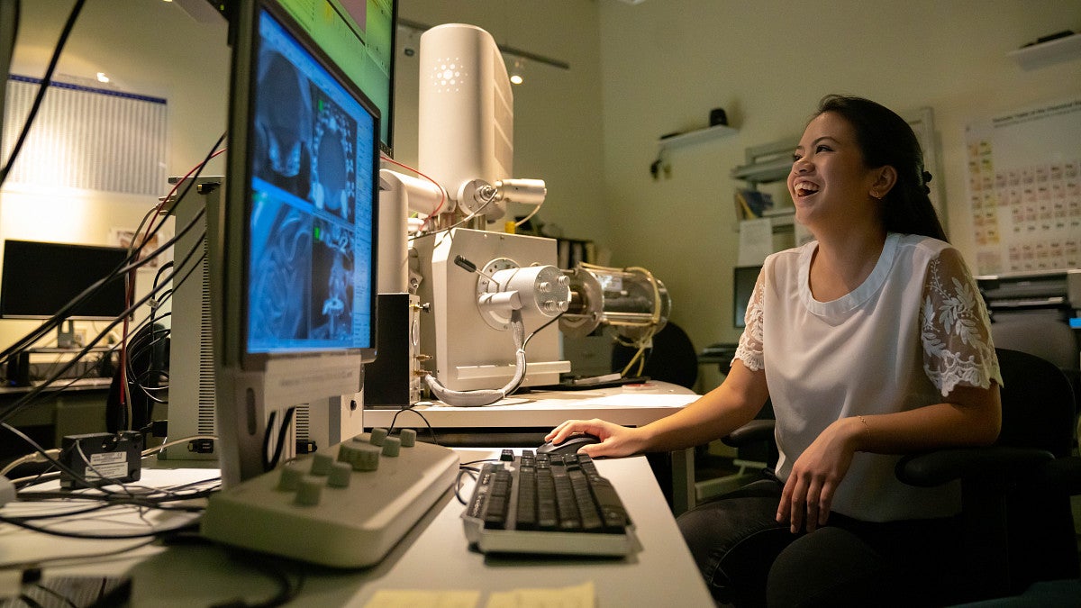 student at computer smiling