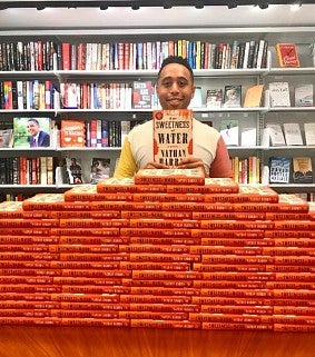 Nathan Harris holds his recent novel