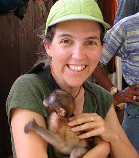 katie lynch elp staff holding a baby monkey