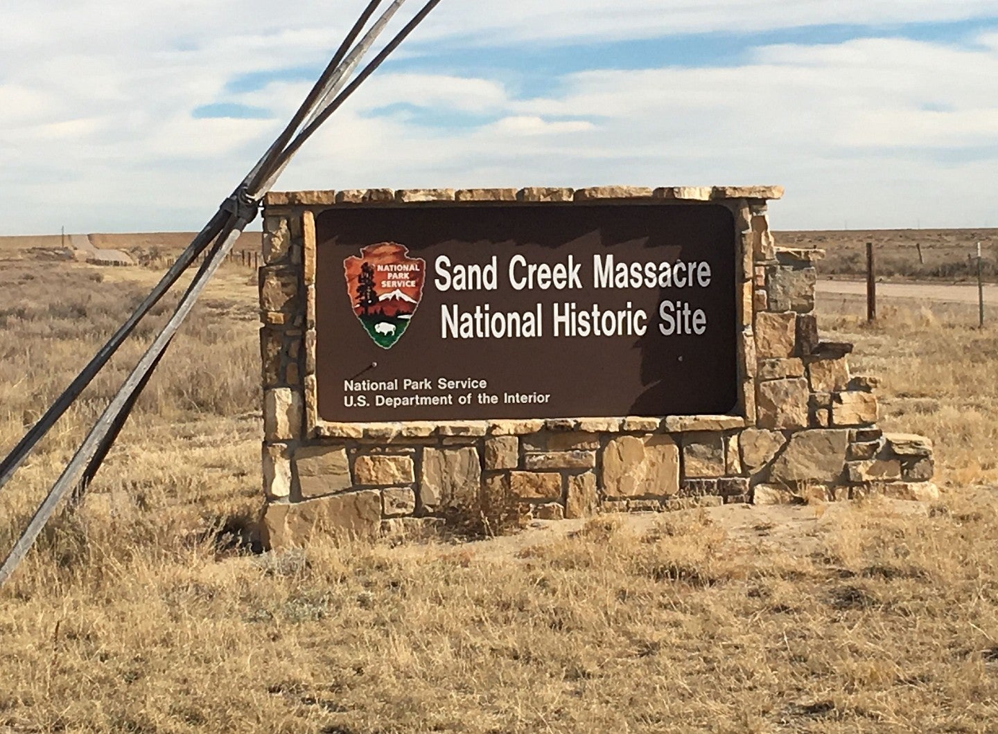 sign for Sand Creek Massacre national historic site in empty grass landscape