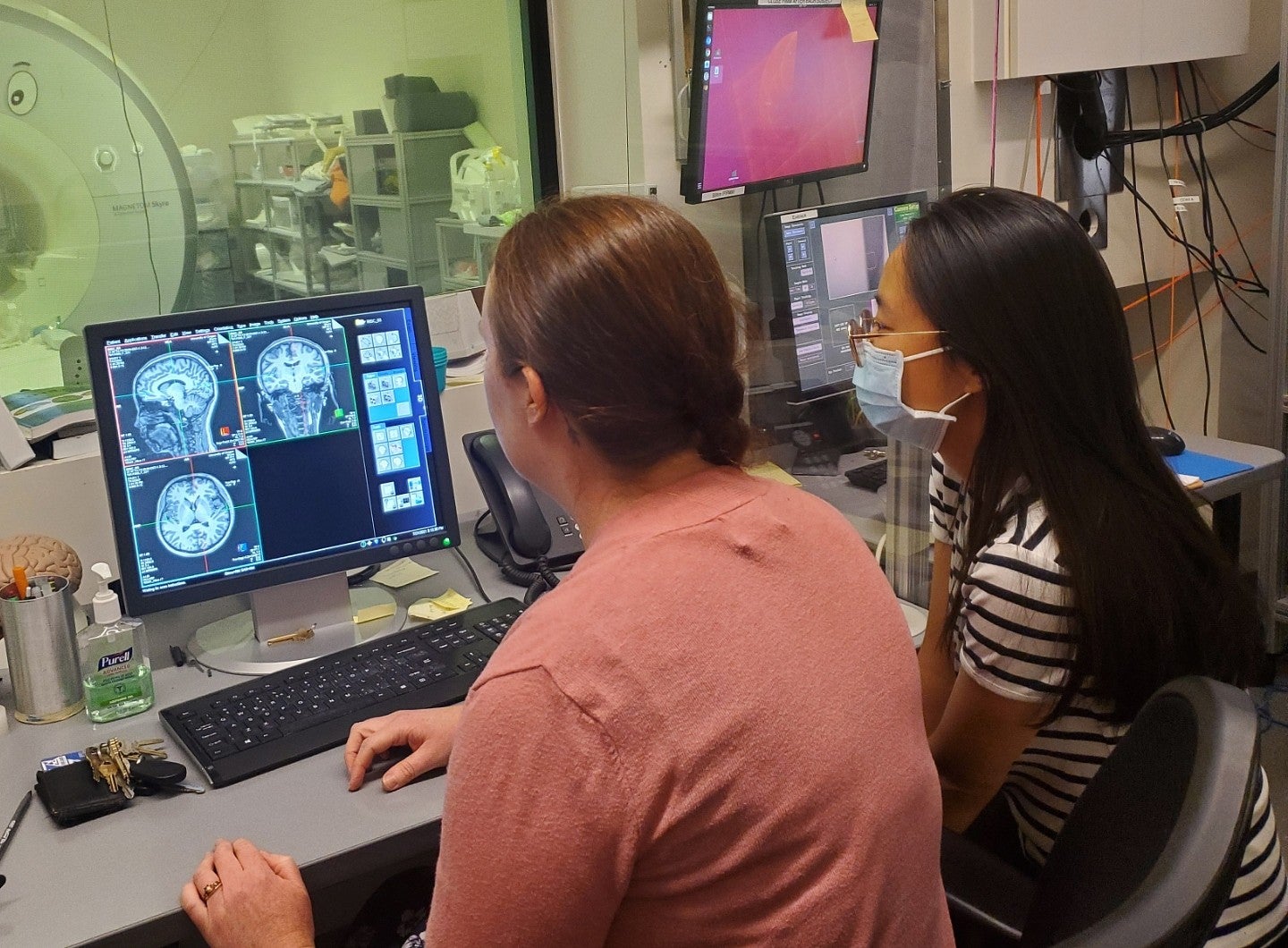 researchers looking at brain scans in exam room