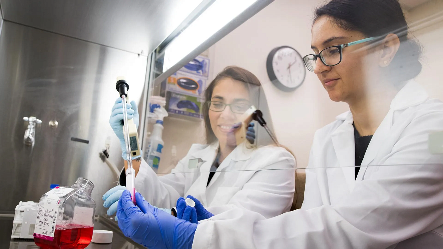 two students in a lab using medical equipment