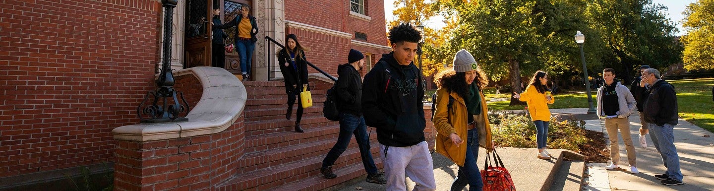 Students leave the brick facade Condon Building on campus