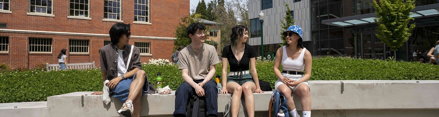 a group of students sit outside