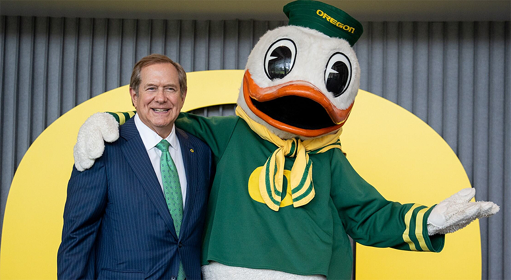 Jordan Schnitzer posing with the Oregon Duck mascot