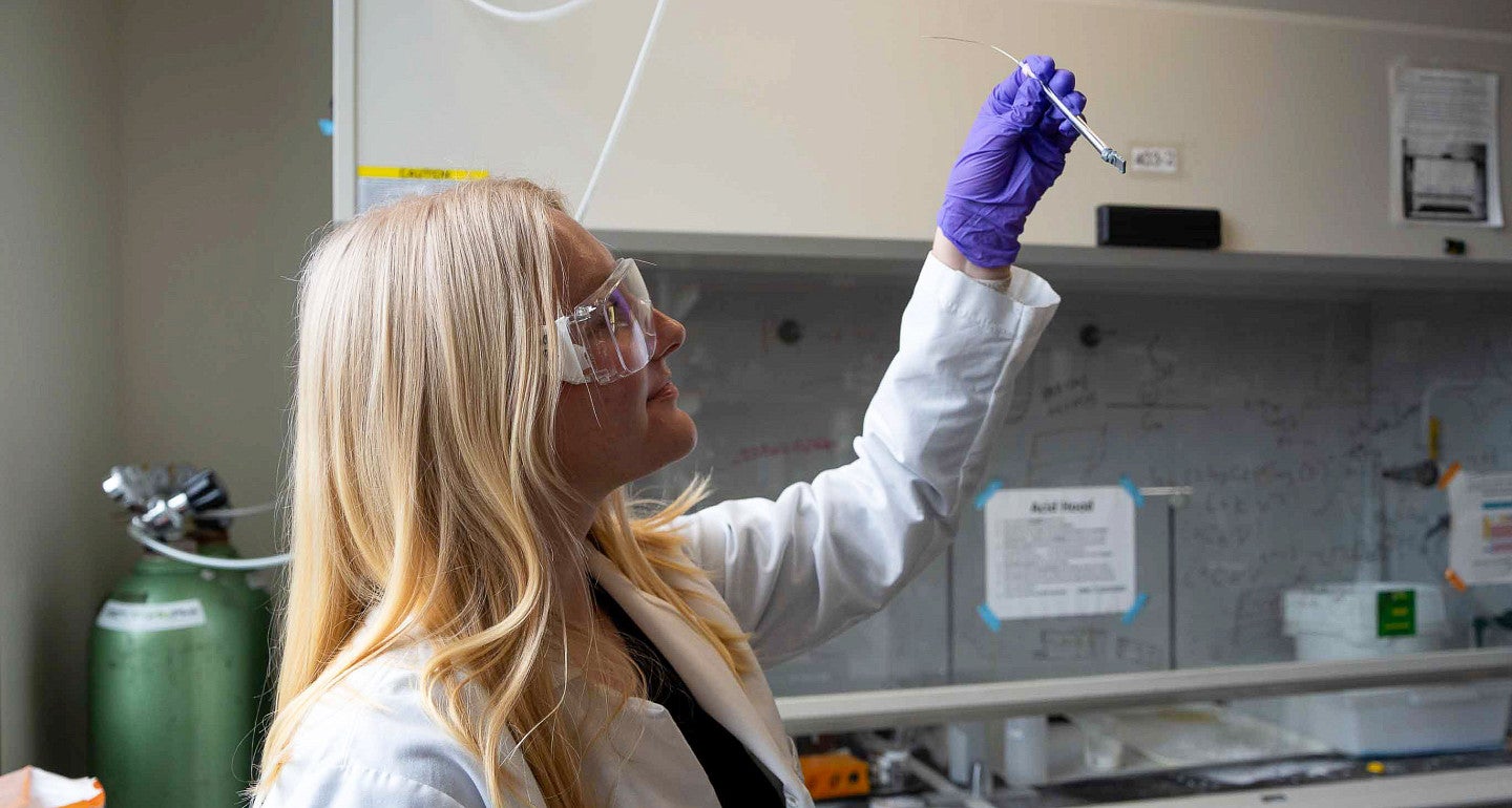 a person holding a vial