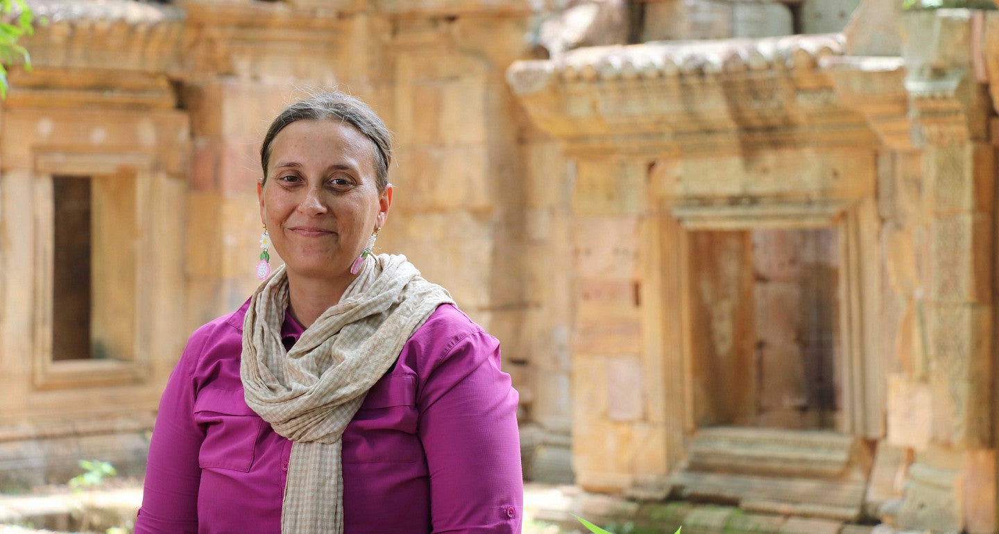 a headshot of Alison Carter in front of an ancient building facade