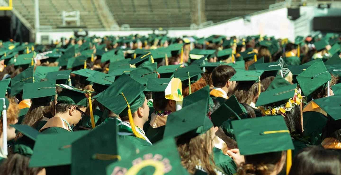 a sea of students wearing cap and gowns