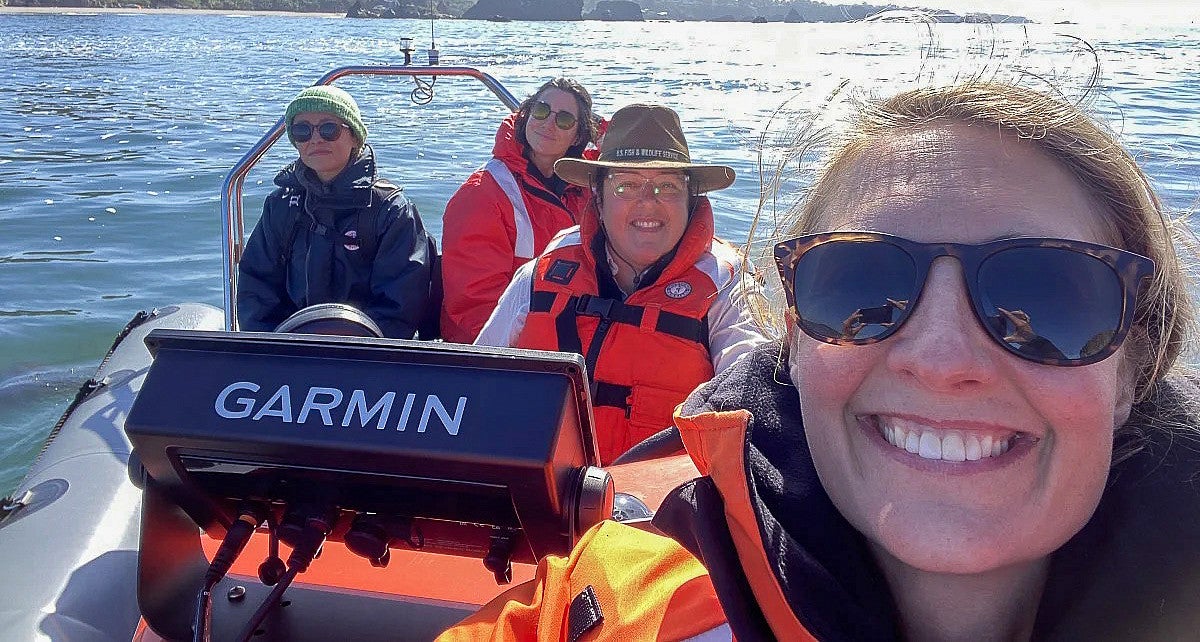 a person on a marine biology boat with three other people