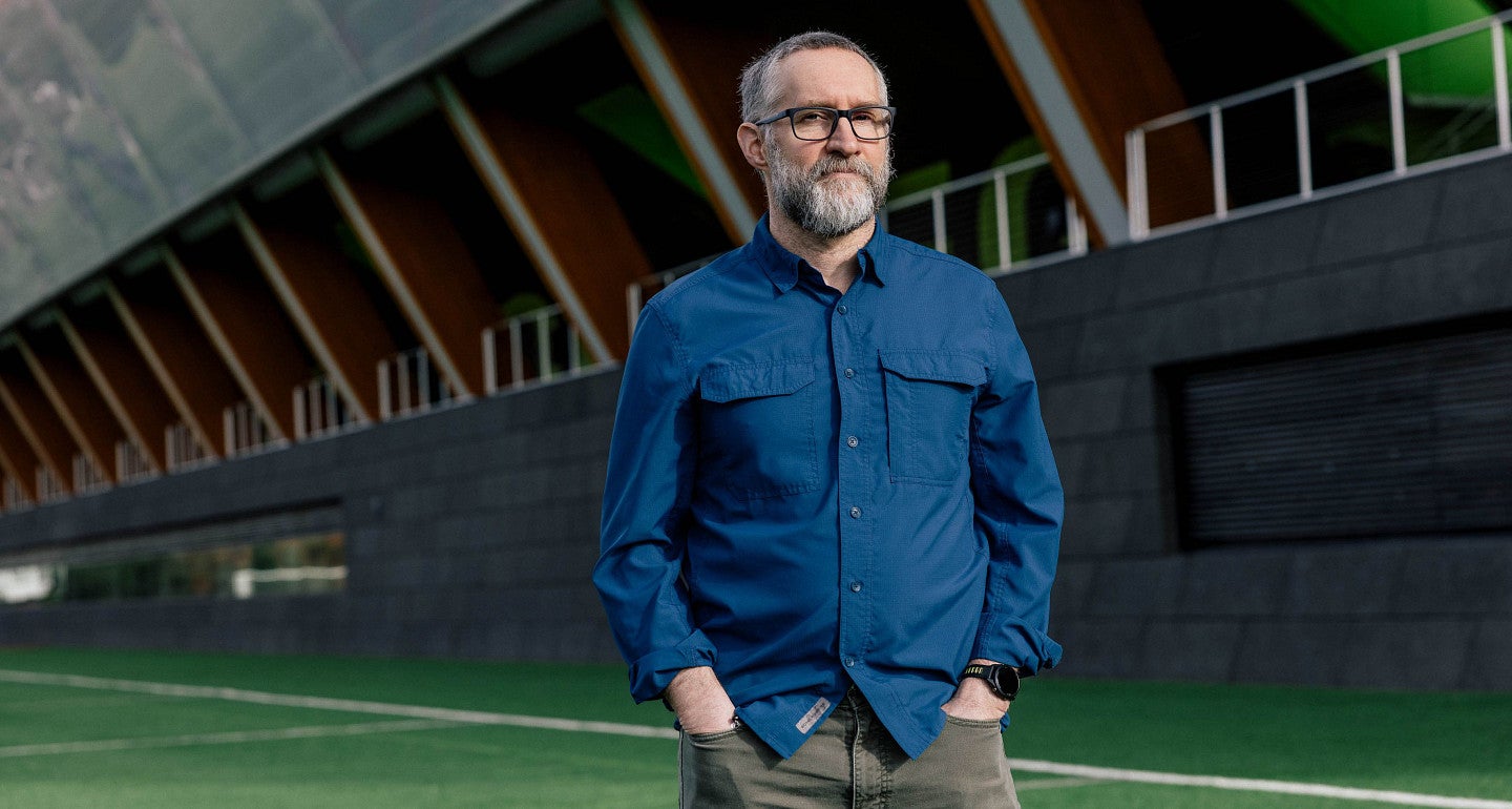 a person stands outside of hayward field on grass