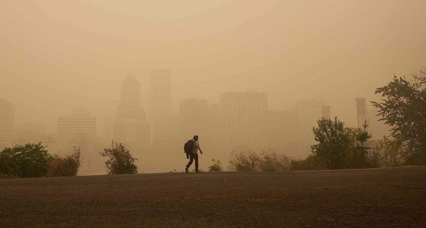 a person walking on a smoke filled horizon