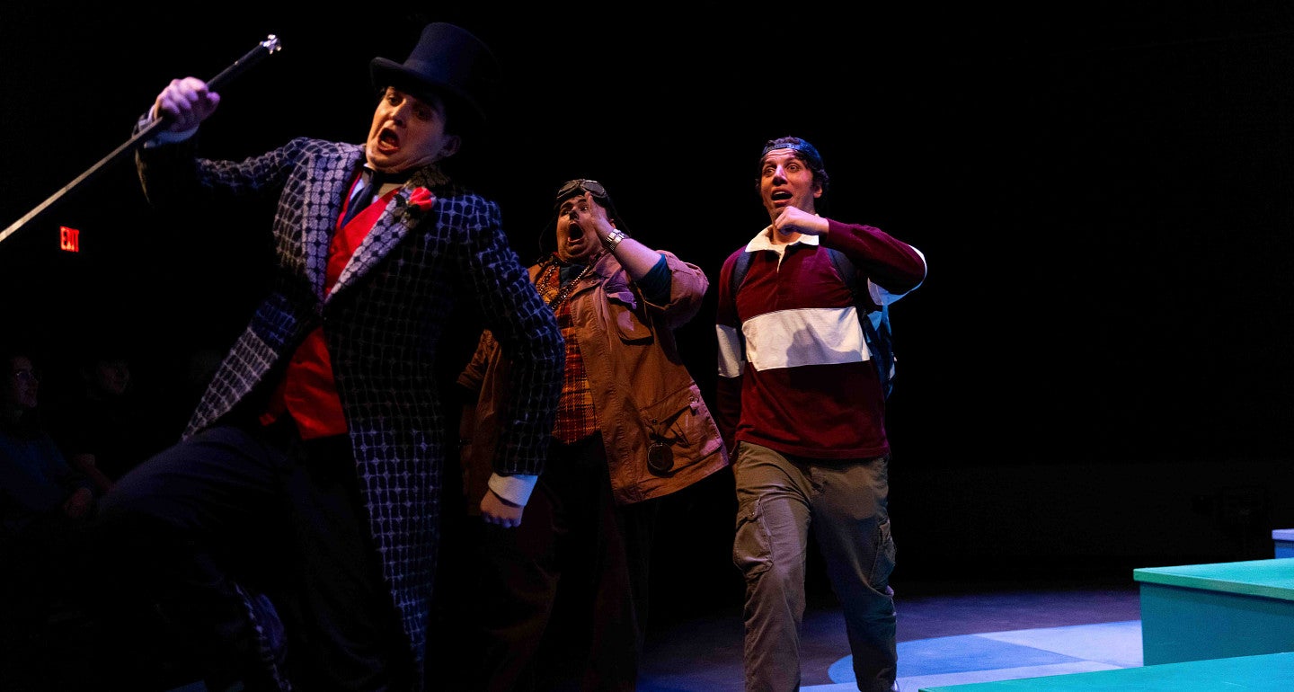 three people walking on stage during a play