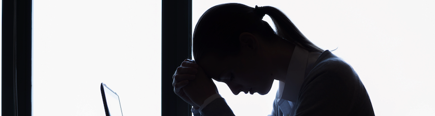 Girl thinking in front of the laptop