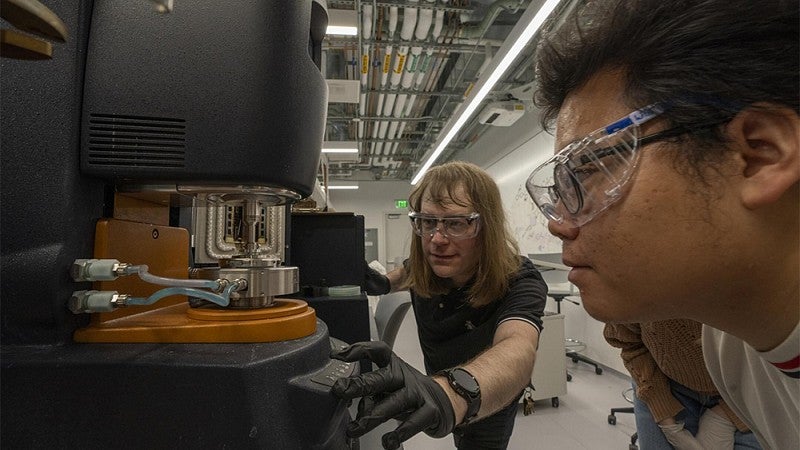 Students operating equipment in a lab