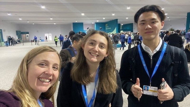 Kaley McCarty with students at COP29 conference