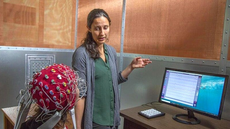 A researcher discusses test results with a volunteer