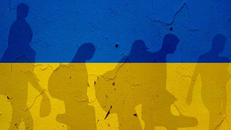 Ukraine flag with shadows of people crossing