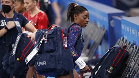 Olympic gymnast Simone Biles wearing a USA backpack
