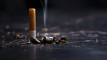 a stubbed-out cigarette next to a pile of ash